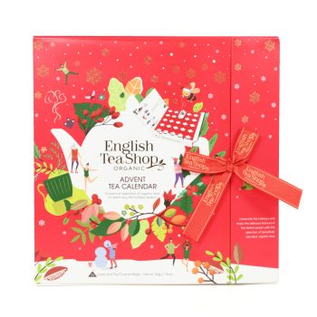 Calendário do Advento em formato de livro vermelho da English Tea Shop, com 25 pirâmides de chá biológico e 13 sabores diferentes, decoração festiva e fita vermelha.